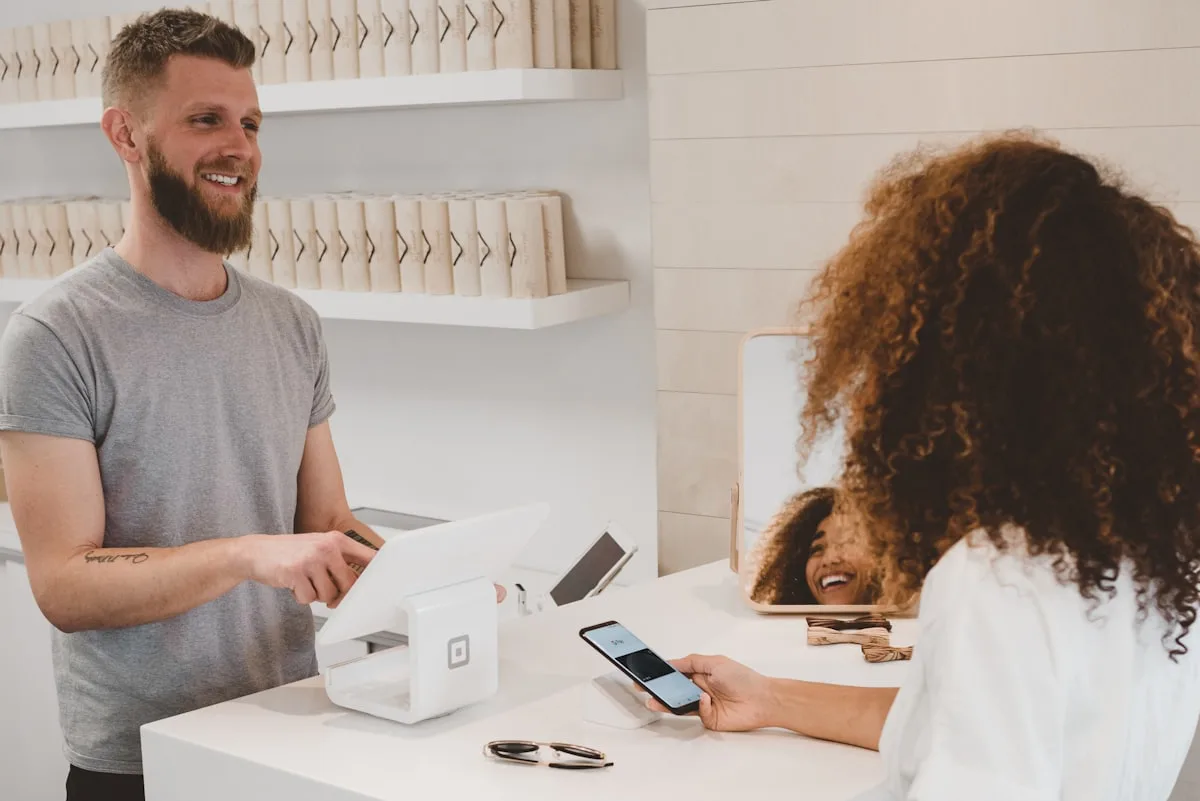 Customer paying by contactless on a card machine linked to a Zivaro till